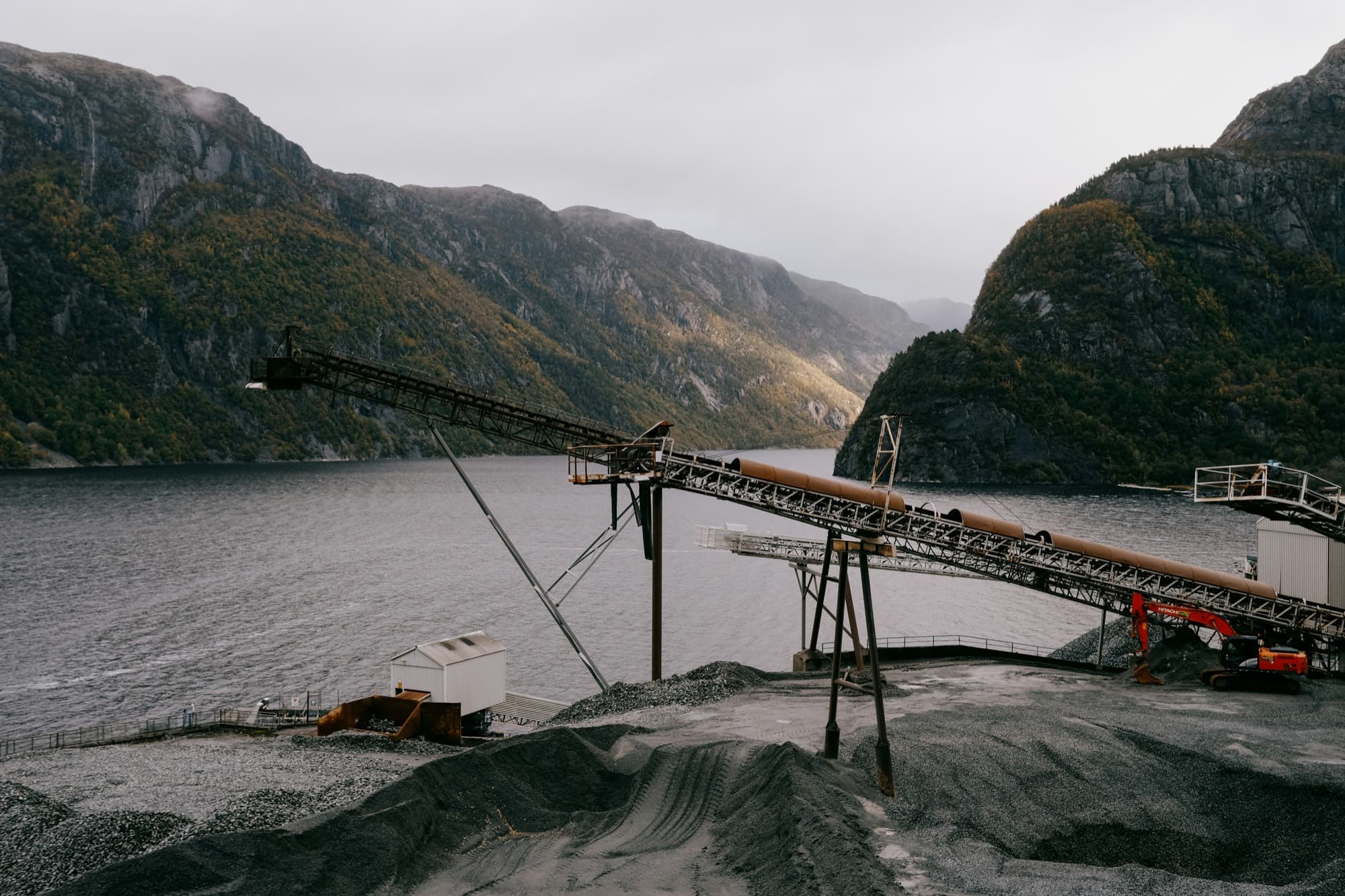 Pukkverk med transportbånd ved en norsk fjord